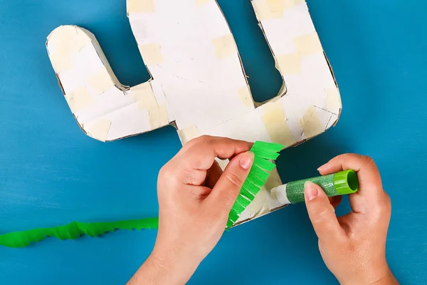 Diy cinco de mayo mexikanische Pinata Kaktus aus Karton, Krepppapier Ihre eigenen Hände blauer Hintergrund — Stockfoto