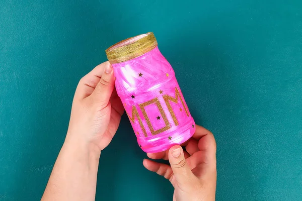 Diy Mothers Day vase with text from a glass jar, pink paint, sparkles glitter, stars, a gold ribbon