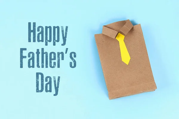 Diy fathers day gift bag package shirt with necktie crafting paper on a blue background. — Stock Photo, Image