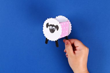 Diy Eid al adha kuzu koyun tatlı şeker kağıt, mavi arka plan üzerinde dondurma için ahşap çubuklar