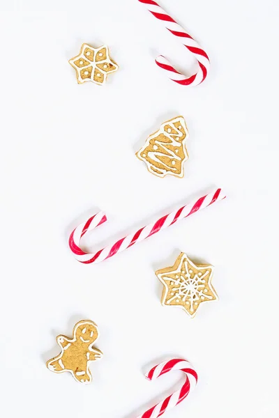 Diseño navideño. Caramelos de caña rayados rojo-blancos y galletas de jengibre caseras — Foto de Stock