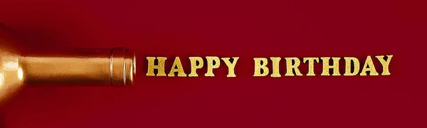 Text Happy birthday laid out of gold letters on beautiful background. Golden bottle neck.