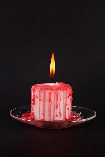 Diy Halloween white candle covered in red wax like blood drops on black background — ストック写真