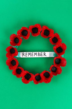 16 Diy wreath red poppy Anzac Day, Remembrance, Remember, Memorial day made of cardboard egg trays on green background. Gift idea, decor. Step by step. Top view. Process kid children craft. Workshop. clipart