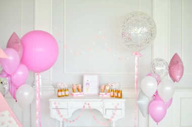 Süslemeleri tatil partisi için. Bir sürü balonlar pembe ve beyaz renkler. Doğum günü partisi için kek. Bir sürü kek ve içecek. 
