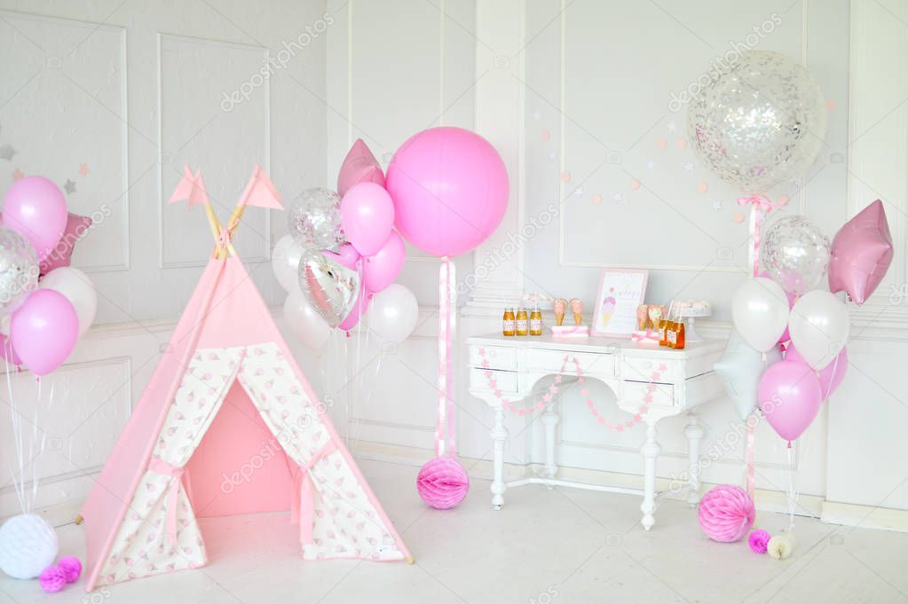 Decorations for holiday party. A lot of balloons pink and white colors. Cakes and drinks for birthday decorations. 