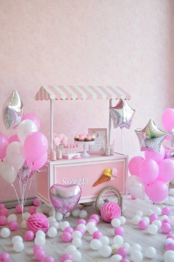 Dekorasyon doğum günü partisi için. Bir sürü kek. Bir sürü balonlar kırmızı ve beyaz renkler. Bir yıl Doğum günü süsleri. Balonlar pembe ve beyaz renkler. Dondurma partisi. 