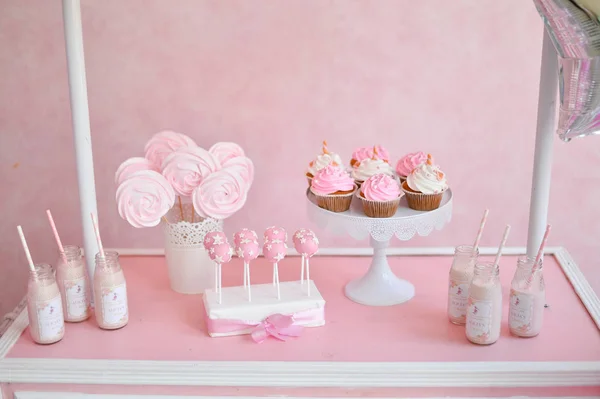 Decorations for birthday party. A lot of cakes. A lot of balloons red and white colors. One year birthday decorations. balloons pink and white colors. Ice cream party.