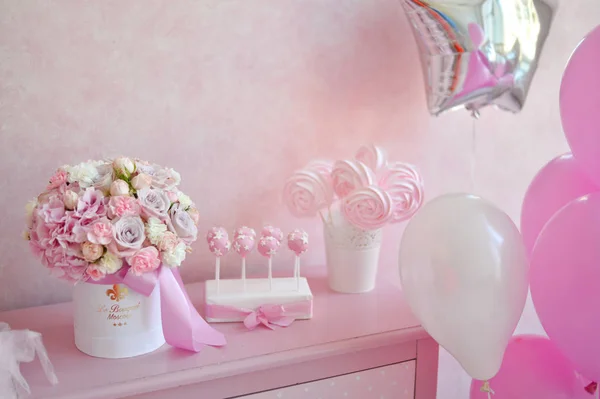 Decorations for birthday party. A lot of cakes. A lot of balloons red and white colors. One year birthday decorations. balloons pink and white colors. Ice cream party.