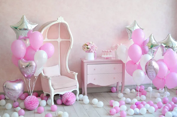 Decorations for birthday party. A lot of cakes. A lot of balloons red and white colors. One year birthday decorations. balloons pink and white colors. Ice cream party.