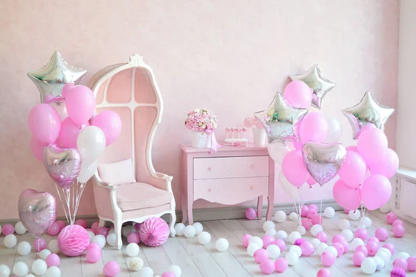 Decorations for birthday party. A lot of cakes. A lot of balloons red and white colors. One year birthday decorations. balloons pink and white colors. Ice cream party.