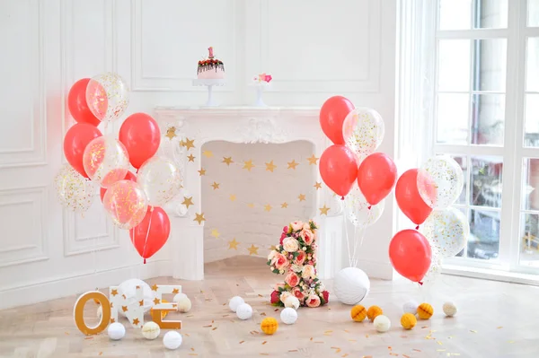 Decorations for birthday party. A lot of cakes. A lot of balloons red and white colors. One year birthday decorations.