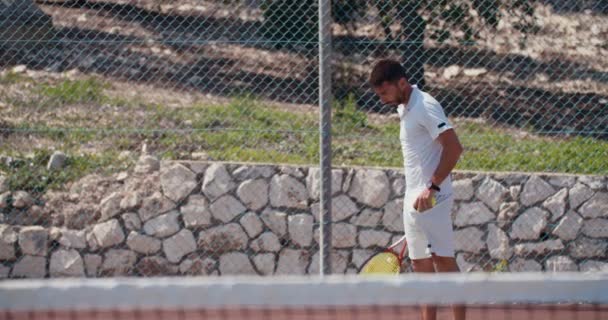 Ein Tennisspieler, der den Ball während eines Tennisspiels schlägt — Stockvideo