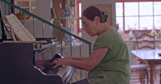 Öregasszony játszik a zongora otthonában — Stock videók