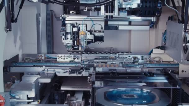 Automated SMT machine placing electronic components on a board — Stock Video