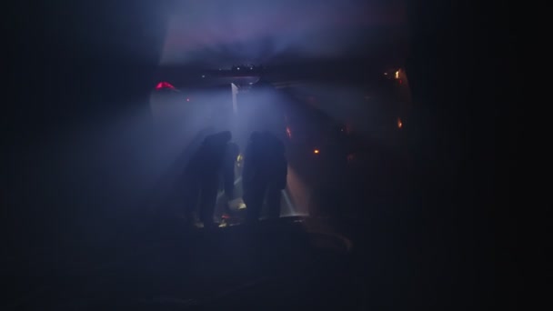 Rescue forces search for survivers inside a dark tunnel using flashlights — Stock Video