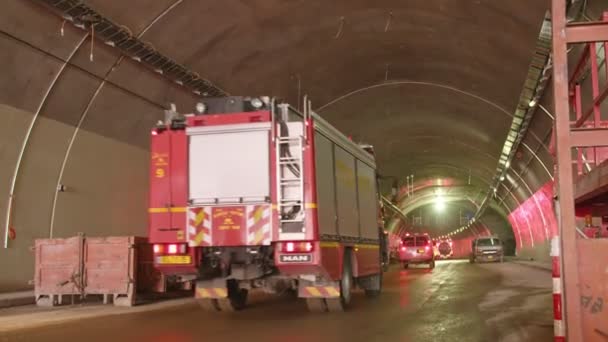 Fire Trucks Entering A Large Tunnel With Red Lights For Rescue