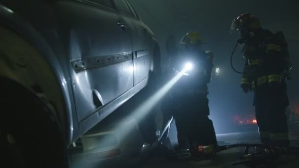 Car accident scene inside a tunnel, firefighters rescuing people from cars — Stock Video