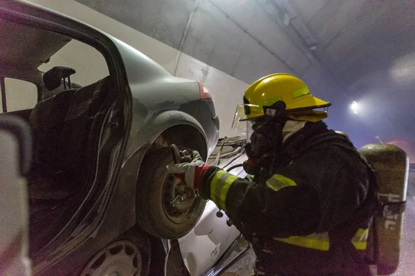 Car accident scene inside a tunnel, firefighters rescuing people from cars — Stock Photo, Image