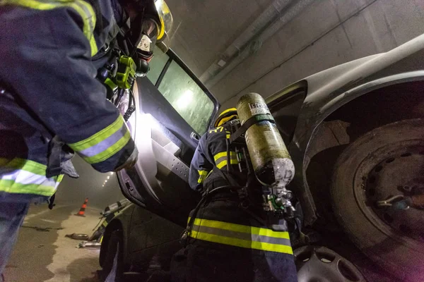 Car accident scene inside a tunnel, firefighters rescuing people from cars — Stock Photo, Image