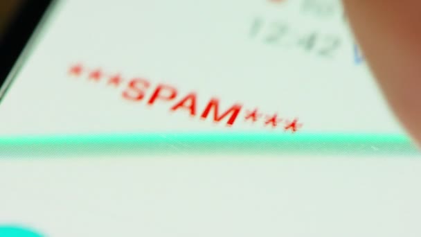 Close up of hand browsing through spam emails on a smartphone screen — Stock Video