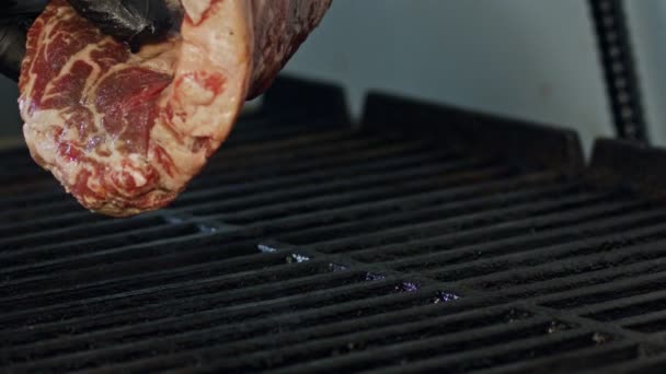 Slow motion of a large beef sirloin steak grilled on a charcoal grill — Stock Video