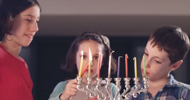 Children lighting Hanukka candles at home — Stock Video