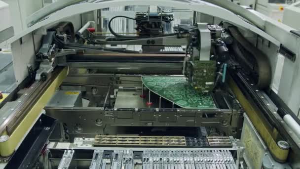 Surface Mount Technology SMT Machine places components on a circuit board — Stock Video