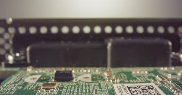 Extreme macro dolly shot of a PCB computer board with capacitors and transistors — Stock Video