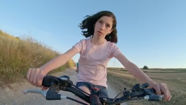 POV egy fiatal lány élvezi a kerékpár út a vidéki táj — Stock videók