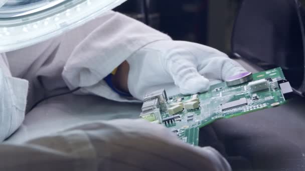 Крупный план ручной пайки электронных компонентов на доске — стоковое видео