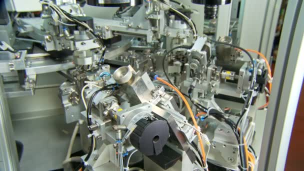 Advanced industrial production line for small parts, robotic arms working — Stock Video