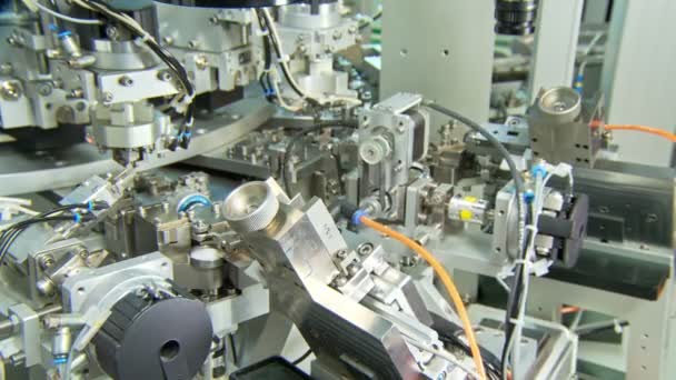 Advanced industrial production line for small parts, robotic arms working — Stock Video