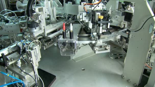 Advanced industrial production line for small parts, robotic arms working — Stock Video