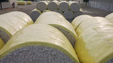 Large stacks of cotton bales at a cotton gin after harvest