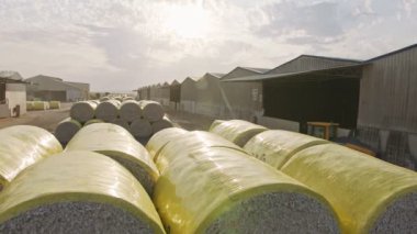 Large stacks of cotton bales at a cotton gin after harvest