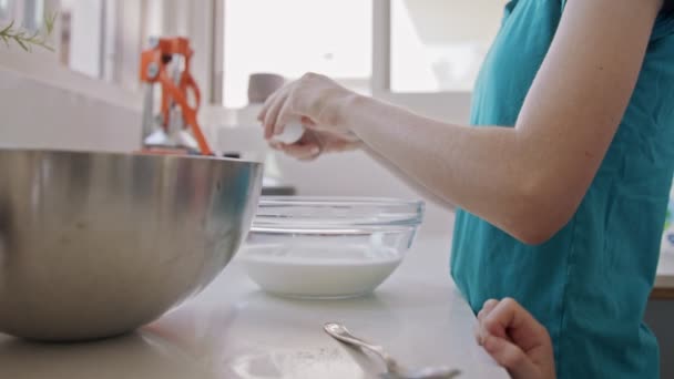 Meisje bereidt en mengt ingrediënten voor pannenkoeken in de keuken — Stockvideo