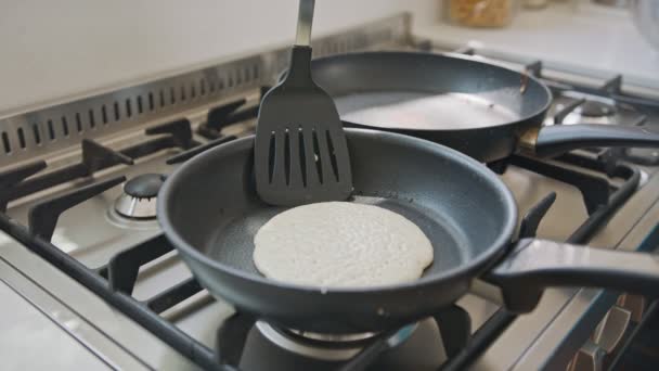 Pancake flipped using a spatula on a frying pan - slow motion — Stock Video