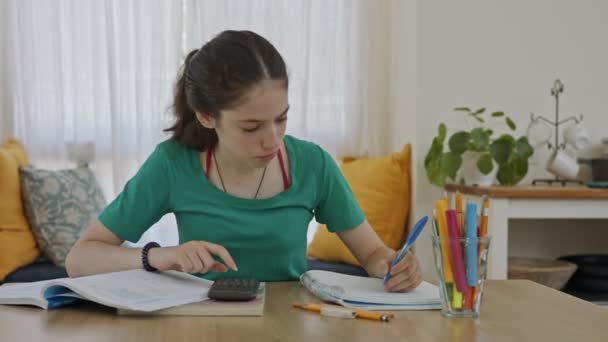 Frusztrált tini lány próbál, és nem készíti elő a házi feladatot az iskolába — Stock videók