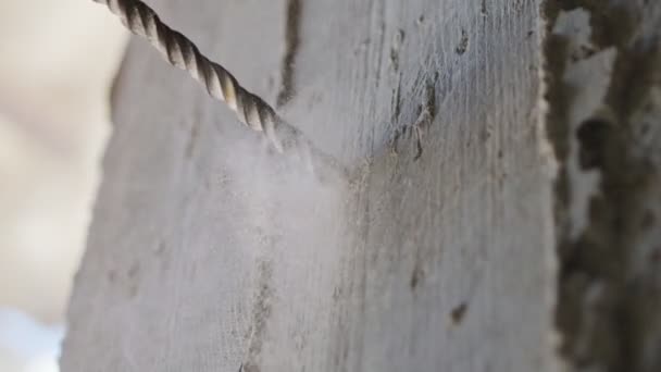 Man drilling hole in concrete wall. Repair works indoors in slow motion — Stock Video