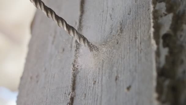 Man drilling hole in concrete wall. Repair works indoors in slow motion — Stock Video