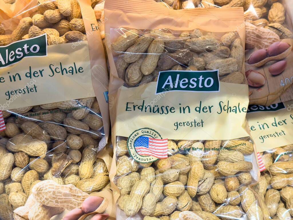 Roasted peanuts in shell packaging with american flag logo in grocery display.