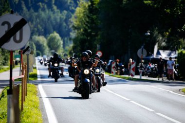 Faaker See, Avusturya - 01 Eylül 2025: Harley-Davidson bisikletli motosikletçiler Avrupa Bisiklet Haftası boyunca resimli bir yolda seyahat ederek özgürlük ve toplum ruhunu yakaladılar