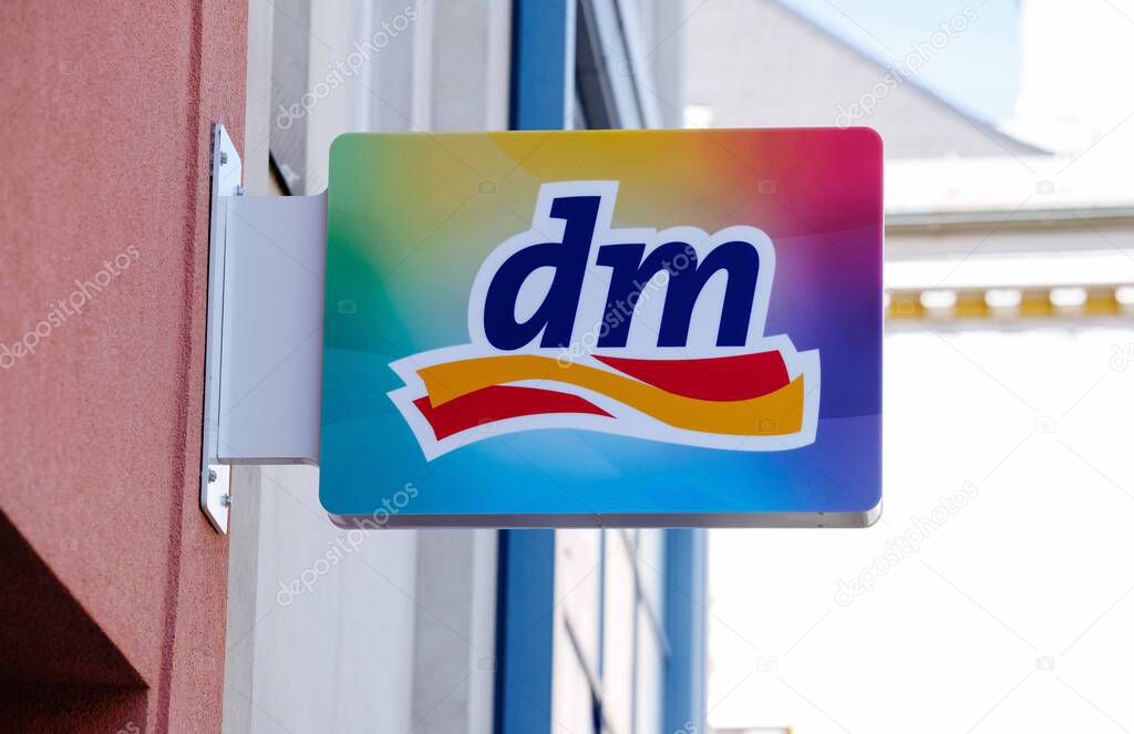 Villach, Austria - September 04, 2025: dm logo sign is prominently featured outside a retail store, highlighting its colorful branding and inviting atmosphere