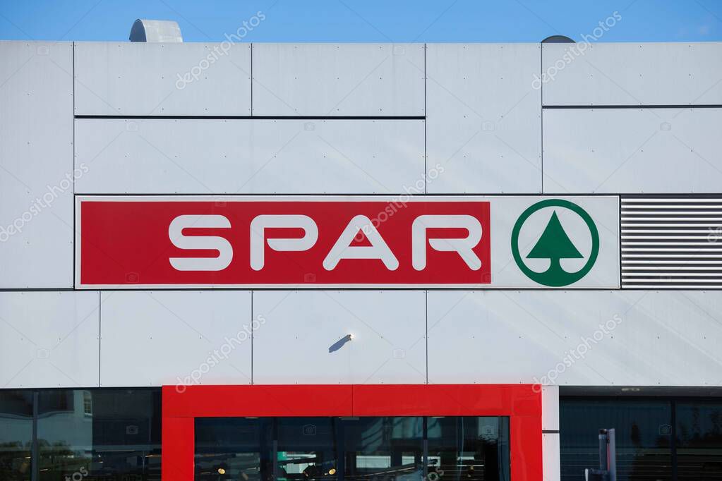 Villach, Austria - September 04, 2025: SPAR store exterior features prominent red sign and green logo, creating a welcoming atmosphere for shoppers