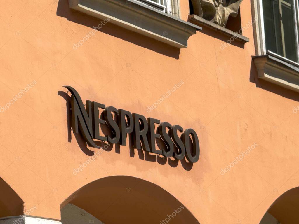 Graz, Austria - September 06, 2025: Nespresso logo is featured on a peach wall, highlighting the brand's identity and inviting atmosphere of the coffee shop