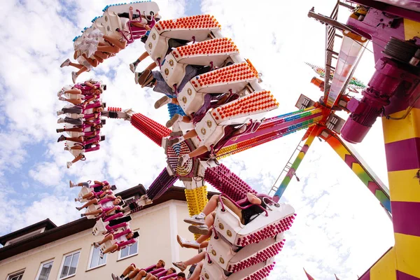 Villach, Avusturya - 30 Temmuz 2025: Villacher Kirchtag festivalinde neşeli binicilerin ve renkli yapıların festival atmosferinde yer aldığı eğlenceli bir gezinti