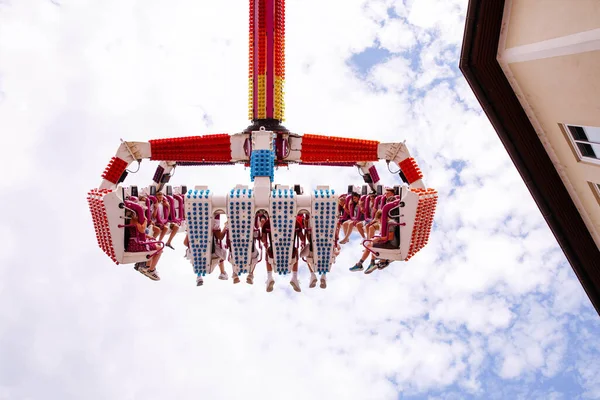 Villach, Avusturya - 30 Temmuz 2025: Villacher Kirchtag festivalinde parlak mavi gökyüzüne karşı yükselen neşeli sürücüler