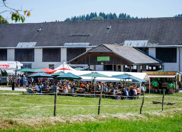 Ossiacher Tauern, Avusturya - 10 Ağustos 2025: Rindfleischfest, doğa ile çevrili pitoresk bir açık hava ortamında şemsiyeler altında canlı bir kalabalığı ağırlıyor