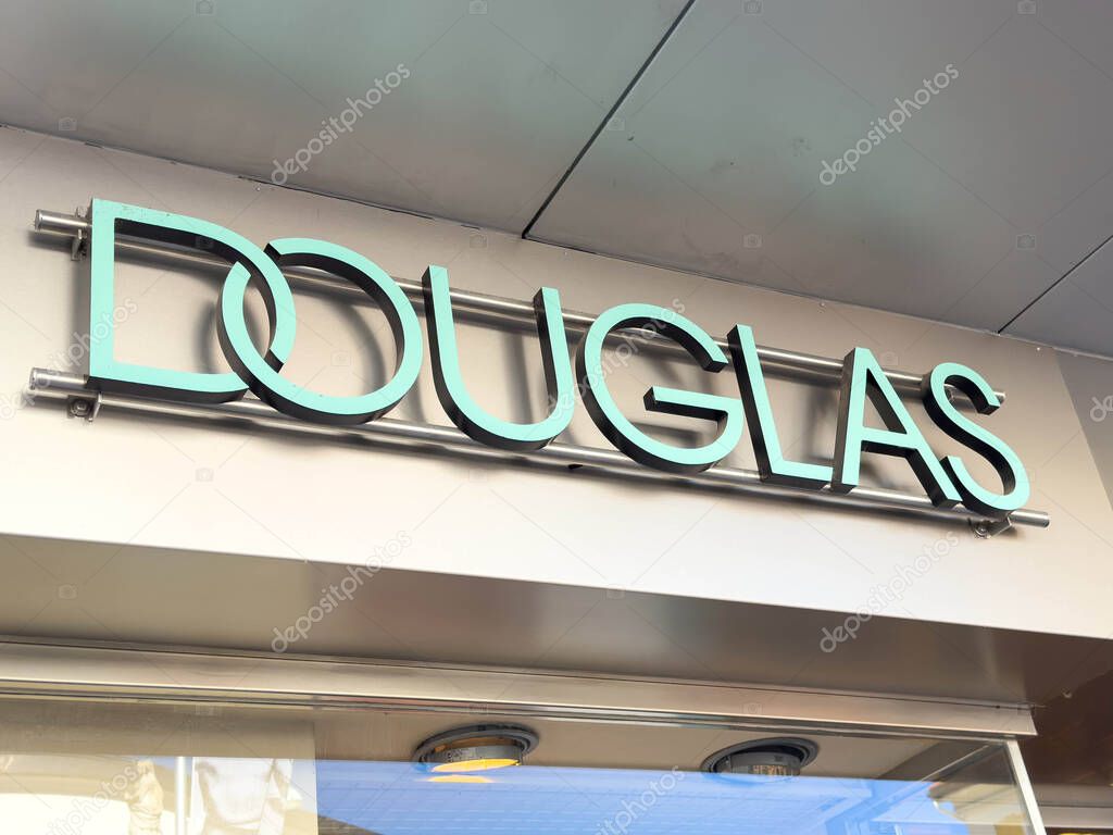 Lienz, Austria - September 18, 2025: Douglas storefront sign features modern design with teal lettering, creating an inviting atmosphere for beauty shoppers